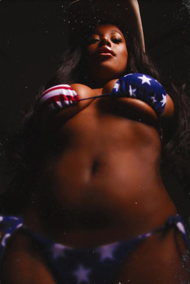 Black busty girl in a stars and stripes bikini