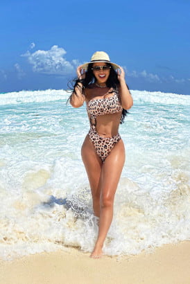 Busty girl in a leopard pattern bikini at the beach